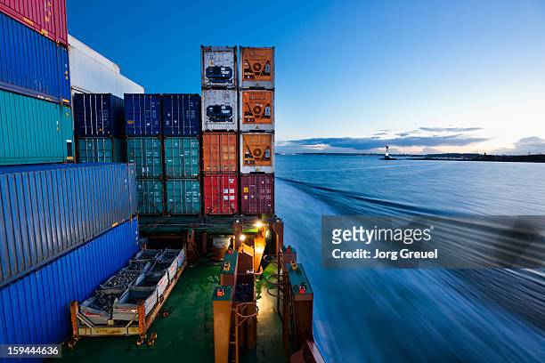 container ship on the baltic sea at dusk - ship stock-fotos und bilder