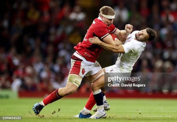 Aaron Wainwright of Wales fends off Danny Care of England during the Summer International match between Wales and England at Principality Stadium on...