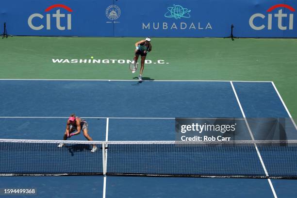 Vera Zvonareva serves with playing partner Laura Siegemund of Germany to Alexa Guarachi of Chile and Monica Niculescu of Romania during the women’s...