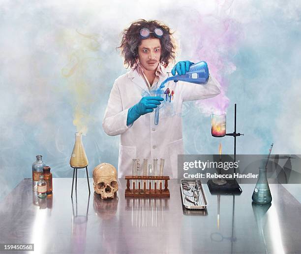 mad scientist in lab with smoke - pallone di vetro foto e immagini stock