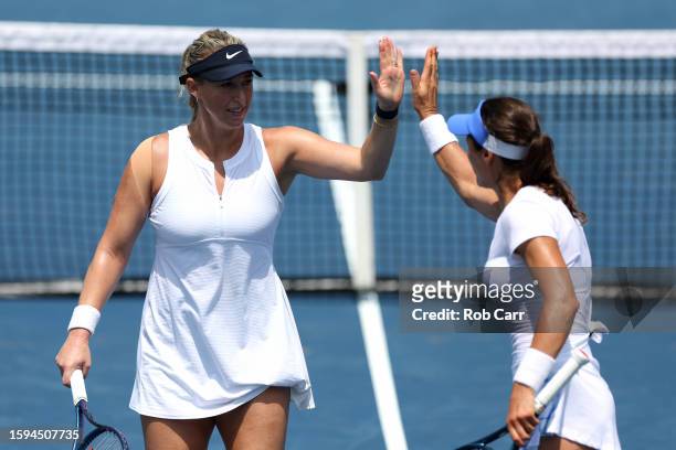 Alexa Guarachi of Chile and playing partner Monica Niculescu of Romania celebrate winning a point against Laura Siegemund of Germany and Vera...