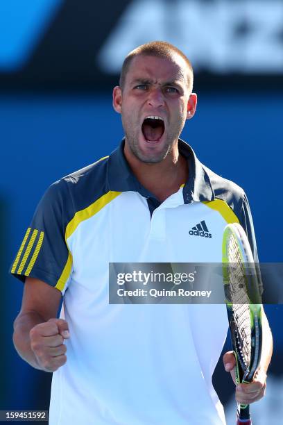 Mikhail Youzhny of Russia celebrates a point in his first round match against Matthew Ebden of Australia during day one of the 2013 Australian Open...