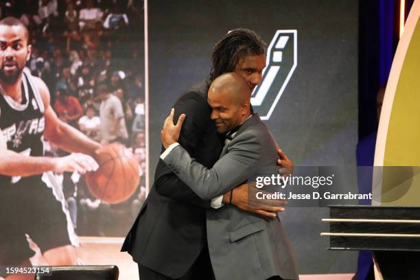 Tony Parker hugs Tim Duncan at the 2023 Basketball Hall of Fame Enshrinement Ceremony on August 12, 2023 at Springfield Marriott in Springfield,...