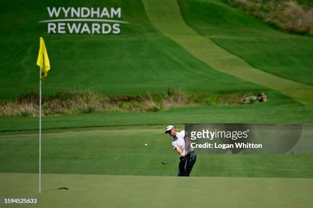 Justin Thomas of the United States chips onto the 12th green during the third round of the Wyndham Championship at Sedgefield Country Club on August...