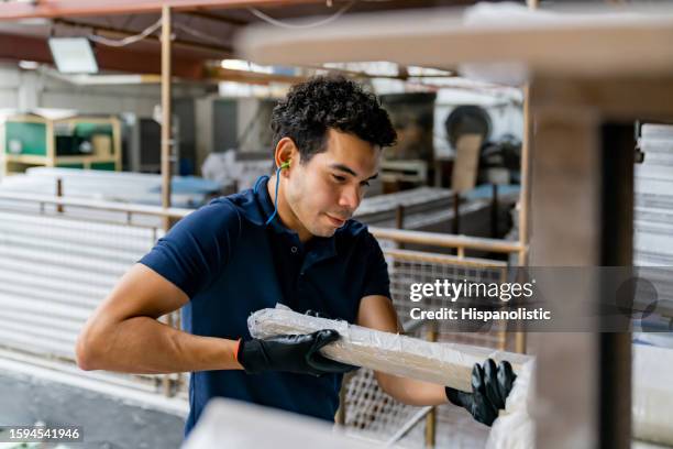 blue-collar worker working at a wood factory and carrying a batten - batten stock pictures, royalty-free photos & images