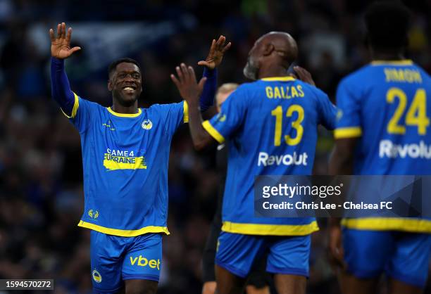 William Gallas of the Blue Team celebrates after scoring their team's second goal with Clarence Seedorf during the Game4Ukraine charity match at...