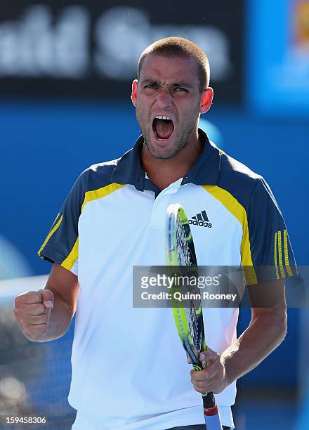 Mikhail Youzhny of Russia celebrates a point in his first round match against Matthew Ebden of Australia during day one of the 2013 Australian Open...