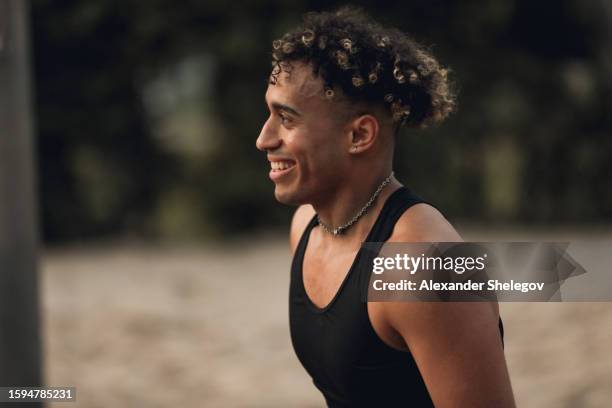 male portrait of the multiracial person who plays beach volleyball. man with ball outside, lifestyle photography with beautiful sports people. - italian ethnicity stock pictures, royalty-free photos & images