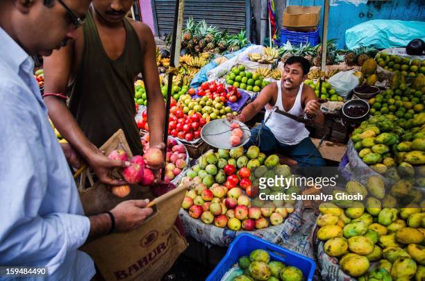 Fruit seller is busy with his business on the streets of Kolkata.