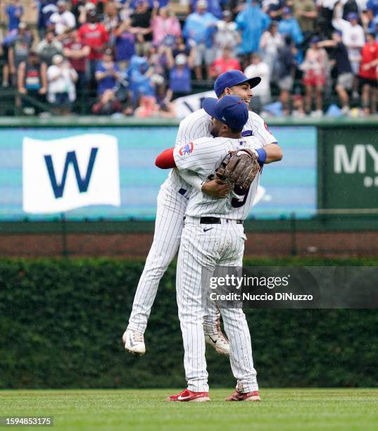 Jeimer Candelario of the Chicago Cubs celebrates with Nick Madrigal of the Chicago Cubs at the end of their team win over the Atlanta Braves at...