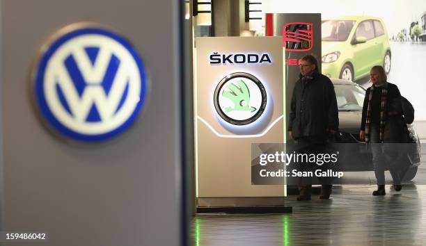 People walk past the logos of Volkswagen, Skoda and Seat at a Volkswagen Group showroom on January 14, 2013 in Berlin, Germany. Volkswagen Group,...