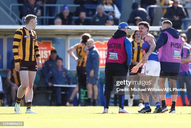 Tom Liberatore of the Bulldogs and James Sicily of the Hawks exchange words during the 2023 AFL Round 22 match between the Hawthorn Hawks and the...