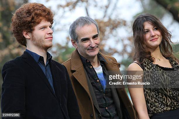 Actor Hugo Conzelmann, director Olivier Assayas and actress Carole Combes attend the 'Apres Mai' photocall at Casa del Cinema on January 14, 2013 in...