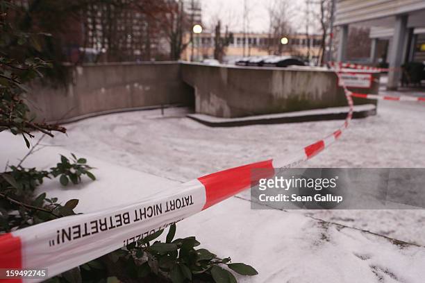 Police tape hangs across the entrance to an underground parking garage next to a locked Steglitz district branch of Berliner Volksbank following a...