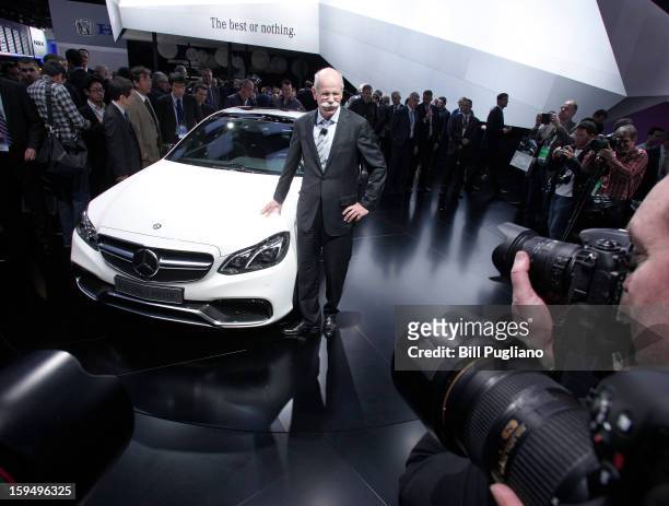 Daimler AG Chairman and CEO Dieter Zetsche poses with the new 2014 Mercedes-Benz E63 AMG at its world debut at the 2013 North American International...