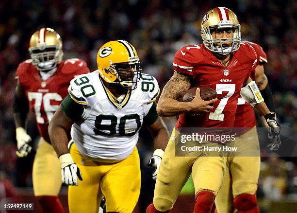 Quarterback Colin Kaepernick of the San Francisco 49ers runs the ball against nose tackle B.J. Raji of the Green Bay Packers during the NFC...