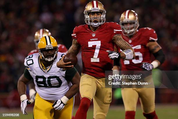Quarterback Colin Kaepernick of the San Francisco 49ers runs the ball against nose tackle B.J. Raji of the Green Bay Packers during the NFC...