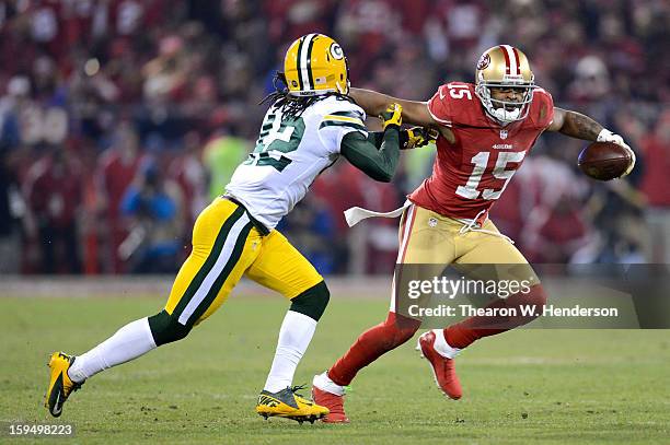 Wide receiver Michael Crabtree of the San Francisco 49ers runs the ball against strong safety Morgan Burnett of the Green Bay Packers during the NFC...