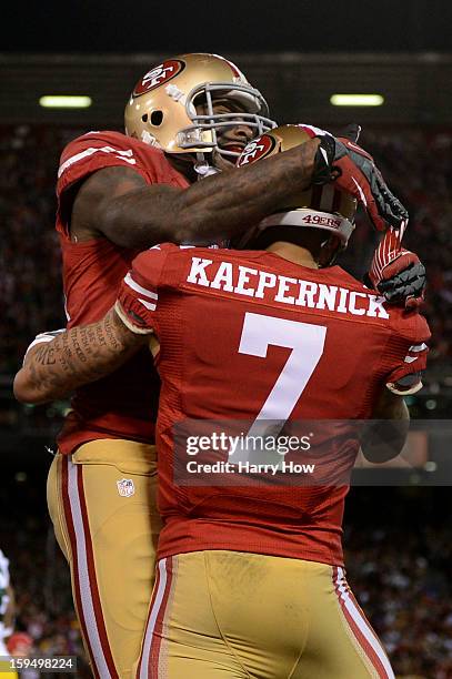 Quarterback Colin Kaepernick of the San Francisco 49ers celebrates with a teammate after running in a touchdown in the first quarter against the...