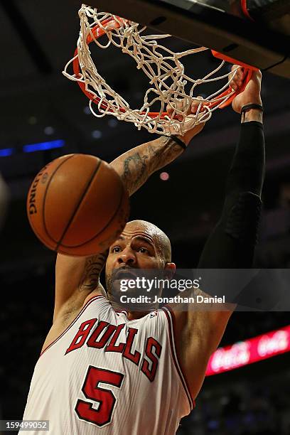 Carlos Boozer of the Chicago Bulls dunks against the Los Angeles Clippers at the United Center on December 11, 2012 in Chicago, Illinois. The...