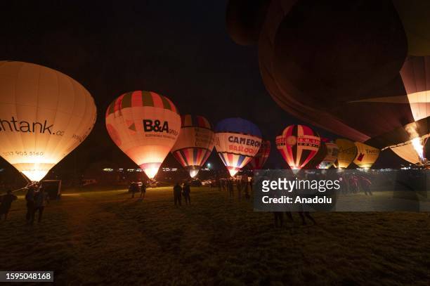 Hot air balloons are being prepared to take off as people gather during the Bristol International Balloon Fiesta on August 12, 2023 in Bristol,...