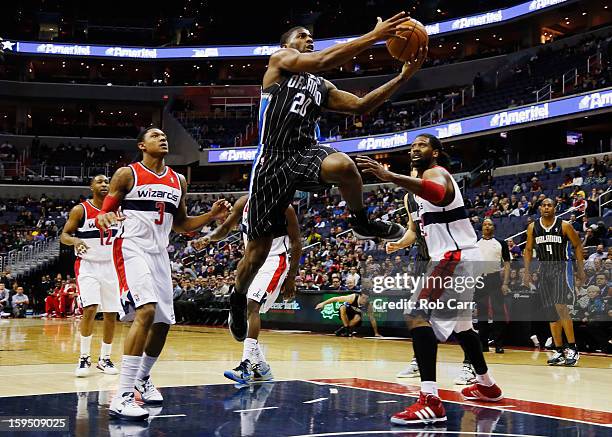 DeQuan Jones of the Orlando Magic puts up a shot in front of Bradley Beal and Nenê of the Washington Wizards during the first half at Verizon Center...