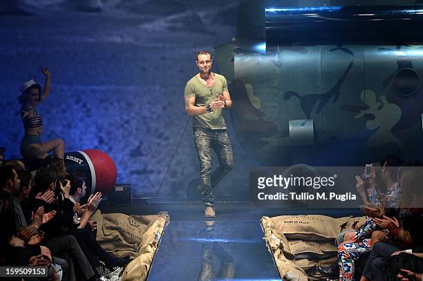 Designer Philipp Plein acknowledges the applause of the audience after the Philipp Plein show during Milan Fashion Week Menswear Autumn/Winter 2013...