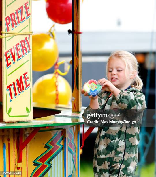 Lena Tindall holds her prize after playing 'hook a duck' on day 2 of the 2023 Festival of British Eventing at Gatcombe Park on August 5, 2023 in...
