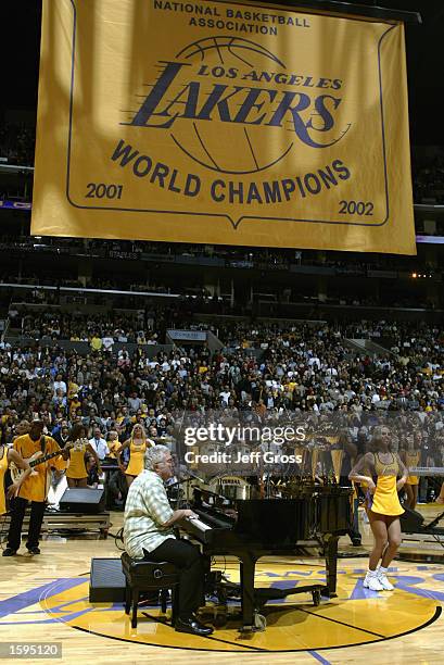 Performer Randy Newman sings during the banner raising ceremony before the NBA season opener between the San Antonio Spurs and the Los Angeles Lakers...