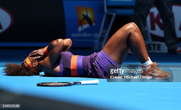 Serena Williams of the United States falls onto the court injuring her ankle in her first round match against Edina Gallovits-Hall of Romania during...