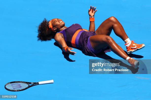 Serena Williams of the United States falls onto the court injuring her ankle in her first round match against Edina Gallovits-Hall of Romania during...