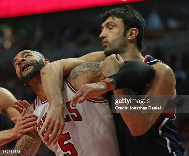 Zaza Pachulia of the Atlanta Hawks hits Carlos Boozer of the Chicago Bulls with his elbow at the United Center on January 14, 2013 in Chicago,...