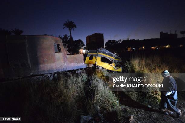 An Egyptian man inspects at the wreckage of a train in the Giza in Badrashin, about 40 km south of Cairo, on January 15 at least 19 people where...