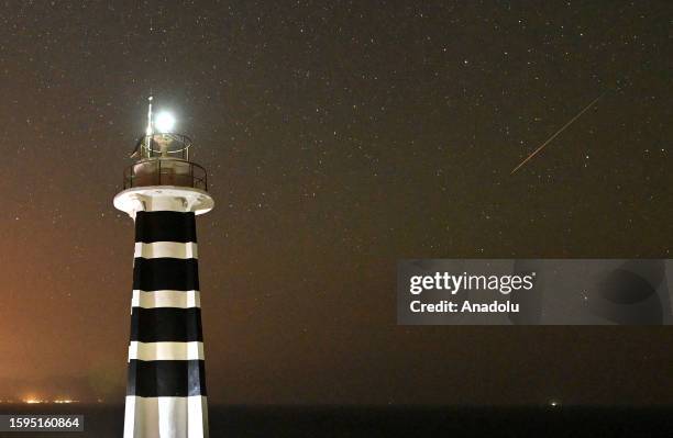 Perseid meteor shower is observed over Sarpincik Lighthouse in Karaburun district of Izmir, Turkiye on August 13, 2023.