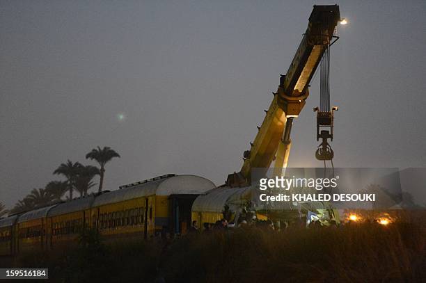 Crain remove the wreckage of a train in the Giza in Badrashin, about 40 km south of Cairo, on January 15 at least 19 people where killed and injured...