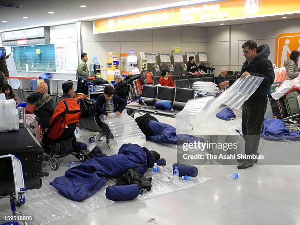 Passengers sleep in the sleeping bags provided by the airline companies due to the flights were cancelled due to the heavy snow and strong wind at...