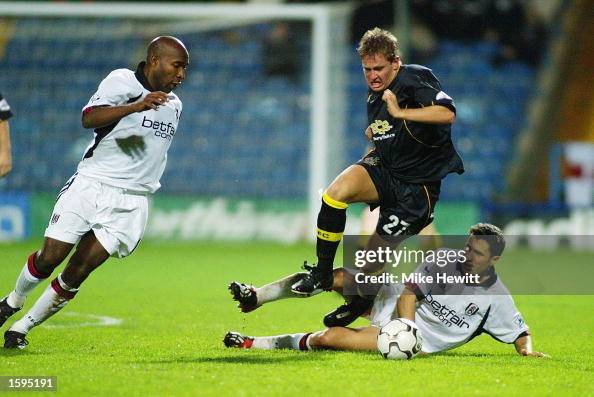 Barry Hayles looks on as Terry Dunfield of Bury is tackled by John Collins Barry Hayles looks on as Terry Dunfield of Bury is tackled by John Collins