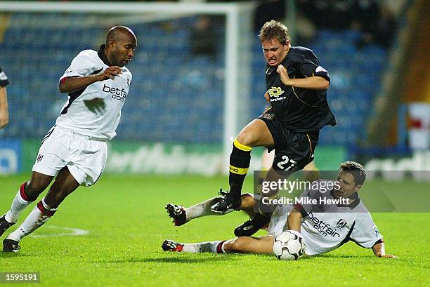 Barry Hayles of Fulham looks on as Terry Dunfield of Bury is tackled by John Collins of Fulham during the Worthington Cup Third Round match between...