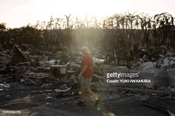 Resident looks around a charred apartment complex in the aftermath of a wildfire in Lahaina, western Maui, Hawaii on August 12, 2023. Hawaii's...