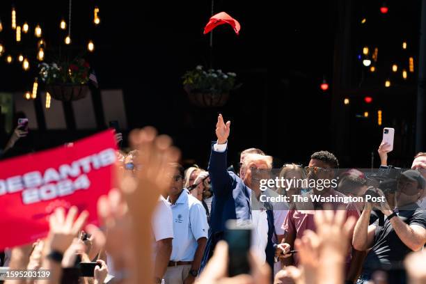 August 12, 2023: Former President Donald Trump toss a hat in the air while supporters cheer for him during the 2023 Iowa State Fair at the Iowa State...