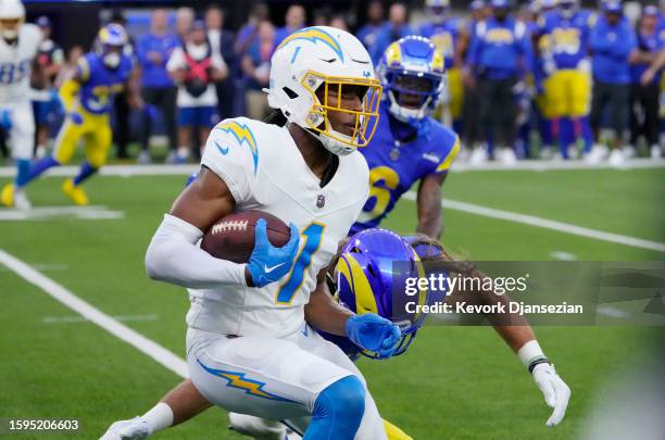 Wide receiver Quentin Johnston of the Los Angeles Chargers catches a pass and runs against the Los Angeles Rams during the first half of pre-season...