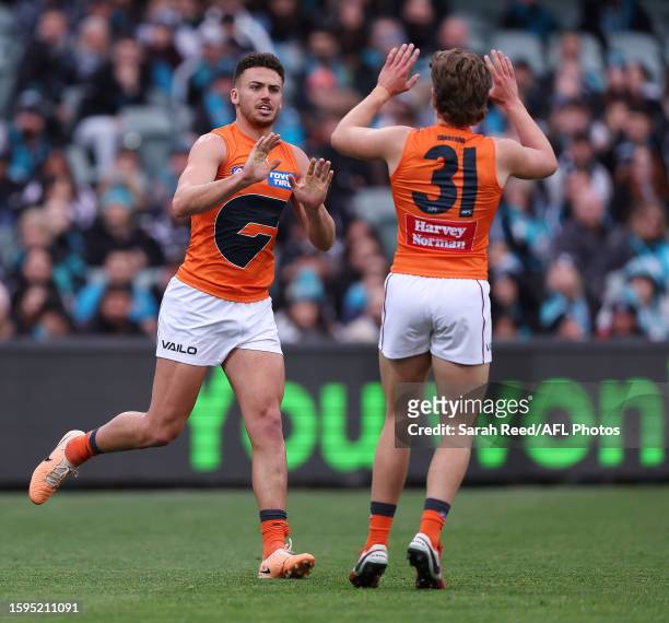 Jake Riccardi of the Giants celebrates a goal with Toby McMullin during the 2023 AFL Round 22 match between the Port Adelaide Power and the GWS...