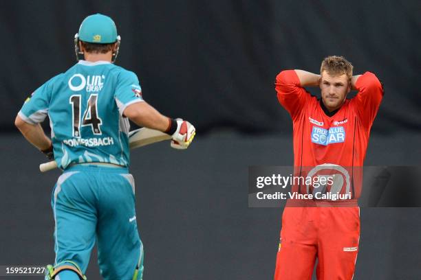 Aaron Finch of the Renegades puts his hands up in despair as Luke Pomersbach of the Heat hits more runs during his innings of 112 during the Big Bash...