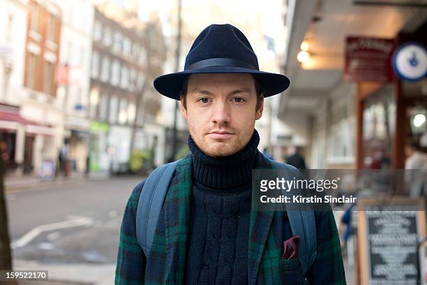 Jonathan Daniel Photographer wearing a Jigsaw suit, Adam Kimmel sweater, Duchamp pocket square and a Laird and Co Hat on day 3 of London Mens Fashion...