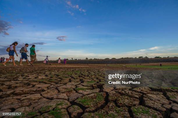 People visit the dried-up Udawalawa reservoir in Udawalawa, Sri Lanka, on August 12, 2023. Udawalawe Reservoir is a reservoir situated on the border...