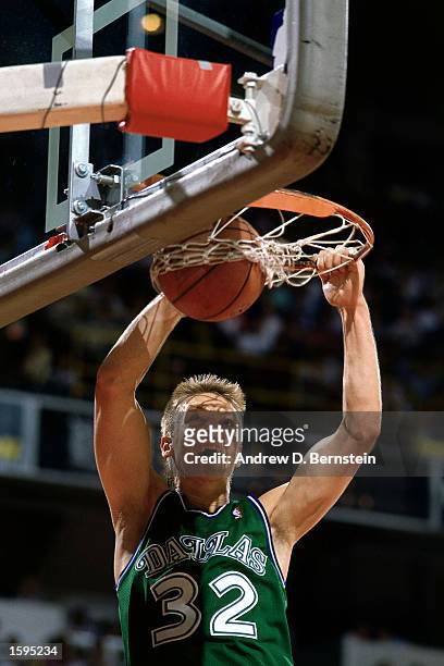 Detlef Schrempf of the Dallas Mavericks dunks during an NBA game. NOTE TO USER: User expressly acknowledges and agrees that, by downloading and or...