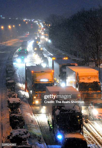 Cars are stuck at a traffic jam in the snow at Tohoku Highway on January 14, 2013 in Motomiya, Fukushima, Japan. A strong low pressure system caused...