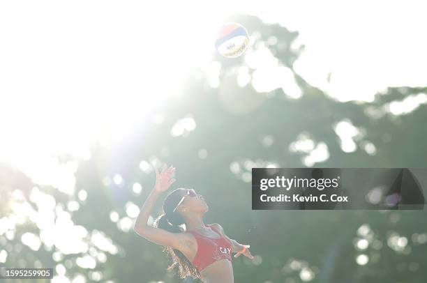 Anjia Delapenha of Team Cayman Islands serves with partner Brianna Delapenha of Team Cayman Islands against Stephanie Joel of Team Vanuatu and Eleno...