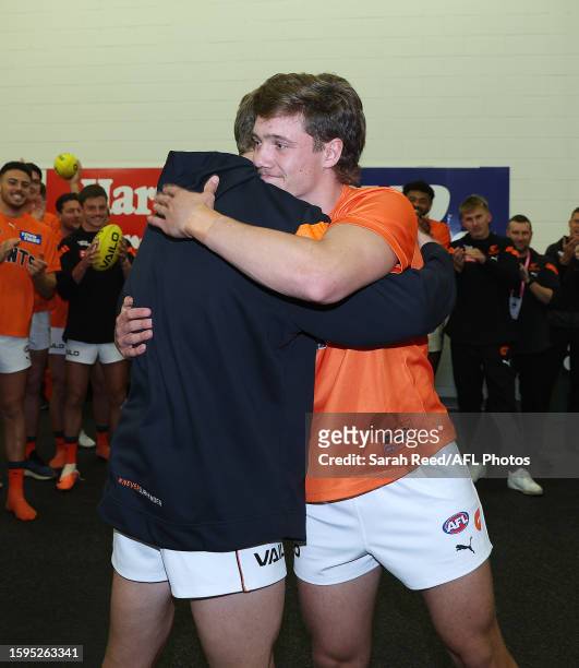 Callan Ward of GWS presents Toby McMullin with. His jumper during the 2023 AFL Round 22 match between the Port Adelaide Power and the GWS GIANTS at...