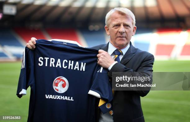 Gordon Strachan poses with a Scotland shirt after being officially presented as the new national team coach of Scotland during a press conference at...